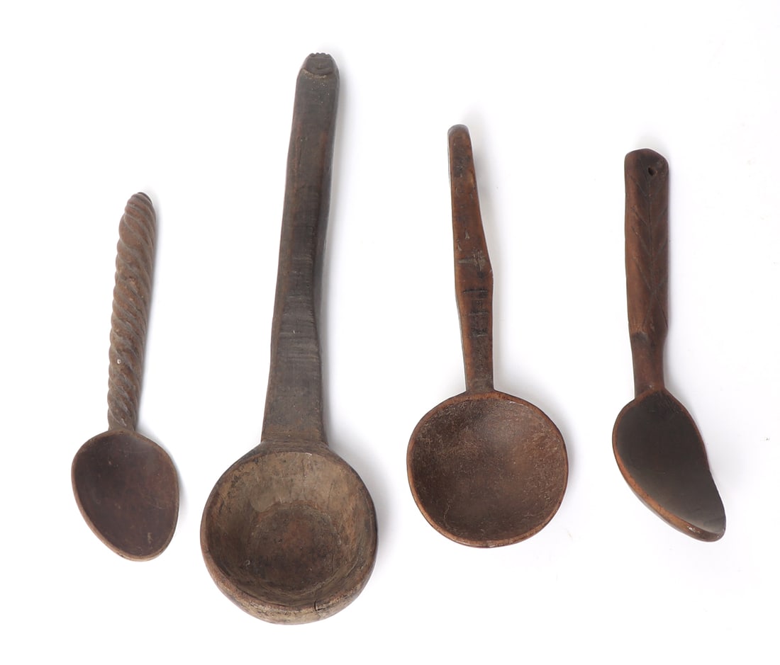 Group of 4 Hand Carved Filipino Spoons: Finely hand carved group of spoons from the Philippines, 20th century. Each with a character or feature of it's own, including a spiral handle, human like incised face finial, rounded shallow bowls, a