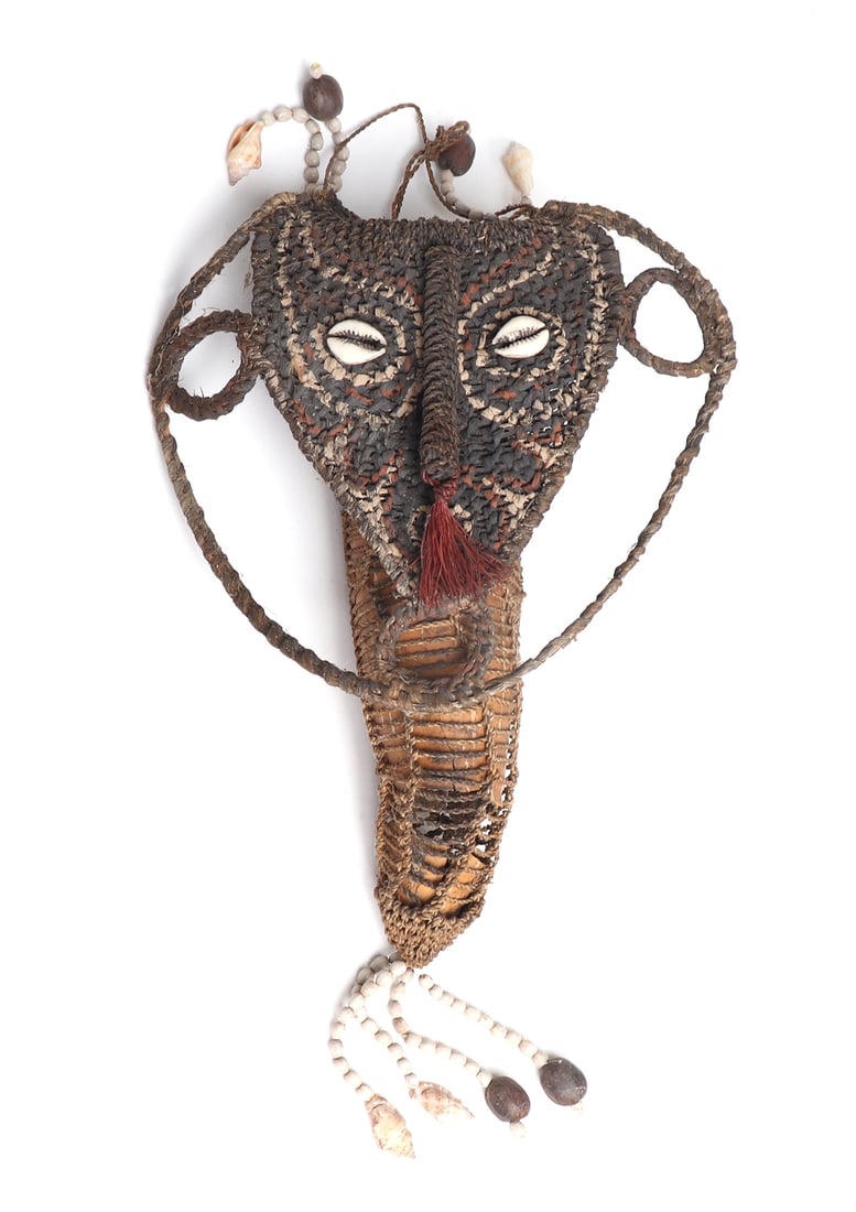 PNG Cowrie Shell and Root Fiber Netted Gourd Bag: Papua New Guinea cowrie shell and root fiber netted Ggurd bag or vessel. Painted mask face in red, black, and white colors cowrie shell eyes to the bag lid. Long nose with red fibers to the base and b