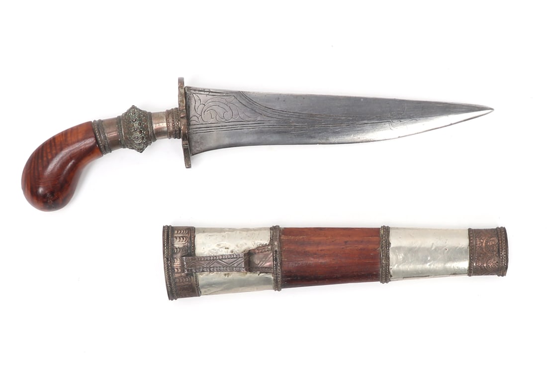 Fine Moro Punal Gunong Dagger: Philippines Archipelagos, Moro Punal Gunong dagger. Fine exotic wood grip and scabbard mounted with silvered copper or coin silver panels engraved with foliate patterns. The blade a single edge with c