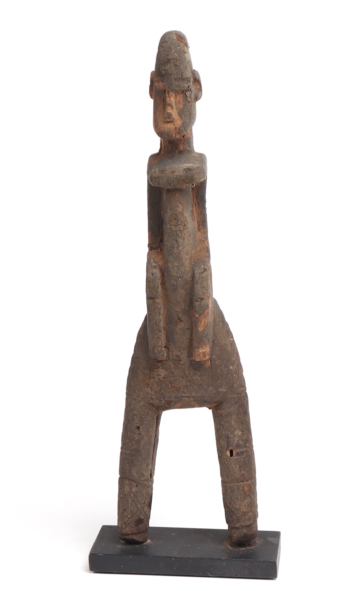 Dogon Female Figural Slingshot, Early 20th c.: West Africa, Mali, Dogon Peoples Early 20th c. Fine and large example of a female form slingshot with wear from use. The female is slightly hunched and wearing a dress incised to the sides and back wi