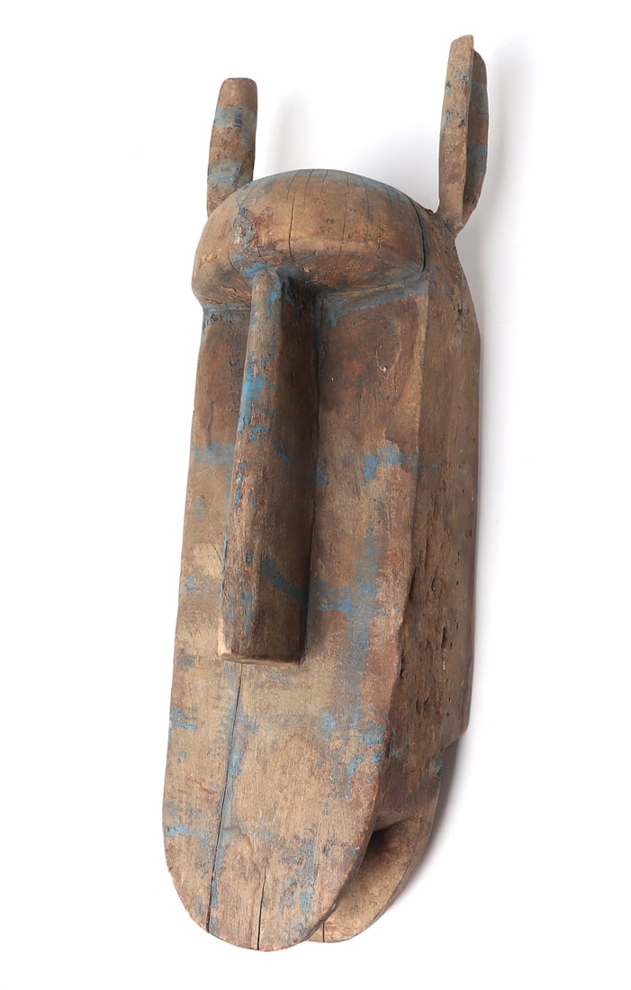 African Wood Carved Mask w/Blue Veins: Handsomely carved from a large single section of wood, this animalistic African mask has applied blue pigment imitating veins throughout. Tall slender ears, and a long bill mouth, raised nose and roun