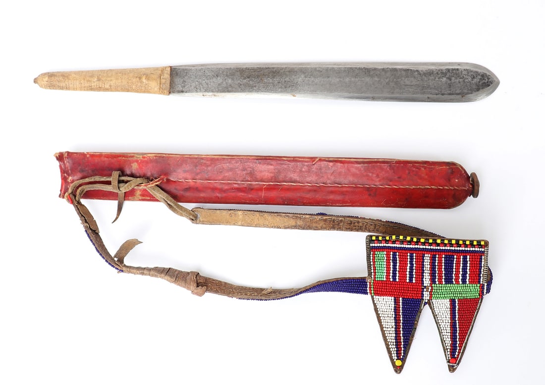 Native Beaded Knife or Short Sword: East Africa, likely Maasai. Finely beaded short sword or knife in dyed red leather scabbard with intricately beaded belt in a vibrantly colored Christian church design. Size 19" L, blade 12" L Maasai