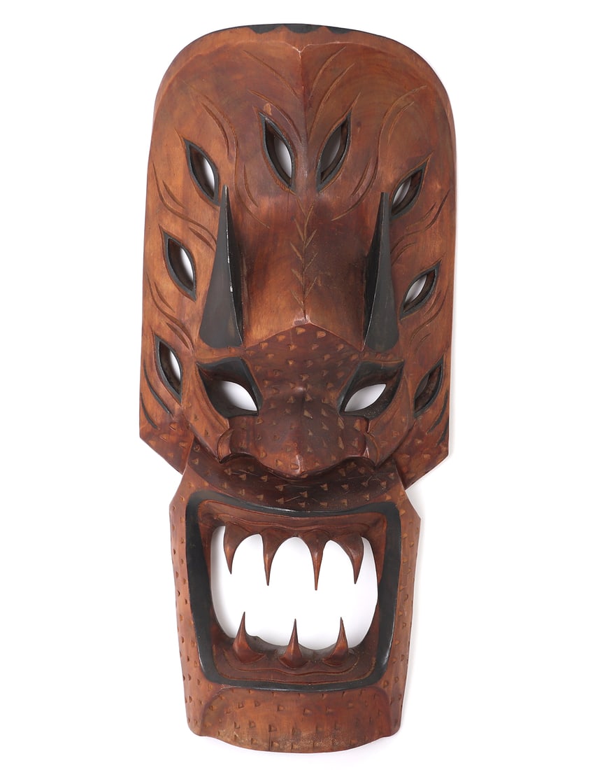 Filipino Bakunawa Mask, 20th Century: Large wood carved Bakunawa mask from the Philippines. Fantastically detailed wood carved mask with large sharp pointed teeth, devilish eyes, terminating spikes, and pierced wood work throughout. Bakun
