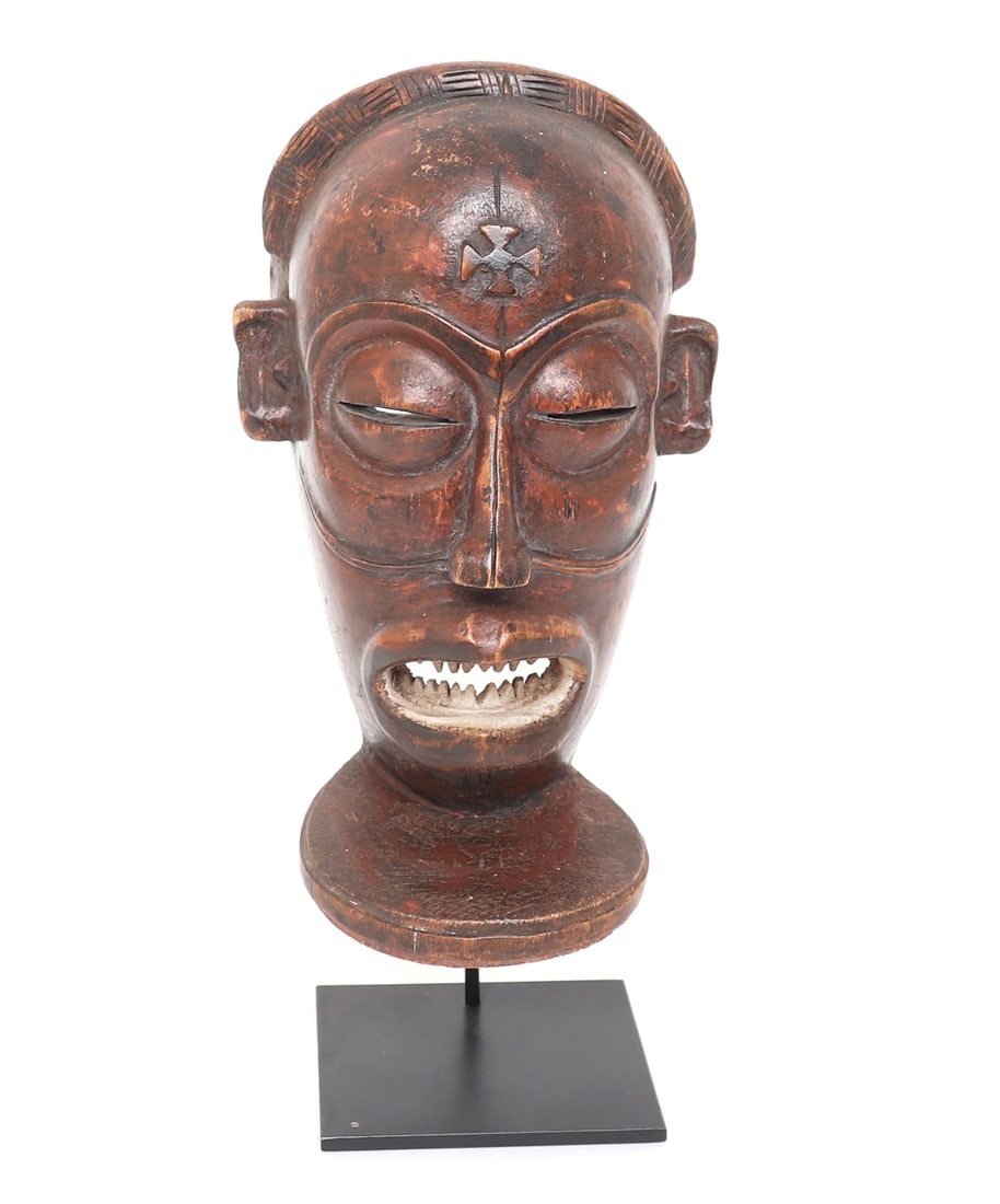 Chokwe Chihongo Wood Carved Mask: Angola, mid-20th century. Wonderfully carved and detailed African Chokwe Chihongo wood carved mask. Slit eyes with slight protruding nose, mouth agape with pointed sharp teeth. Incised geometric detai