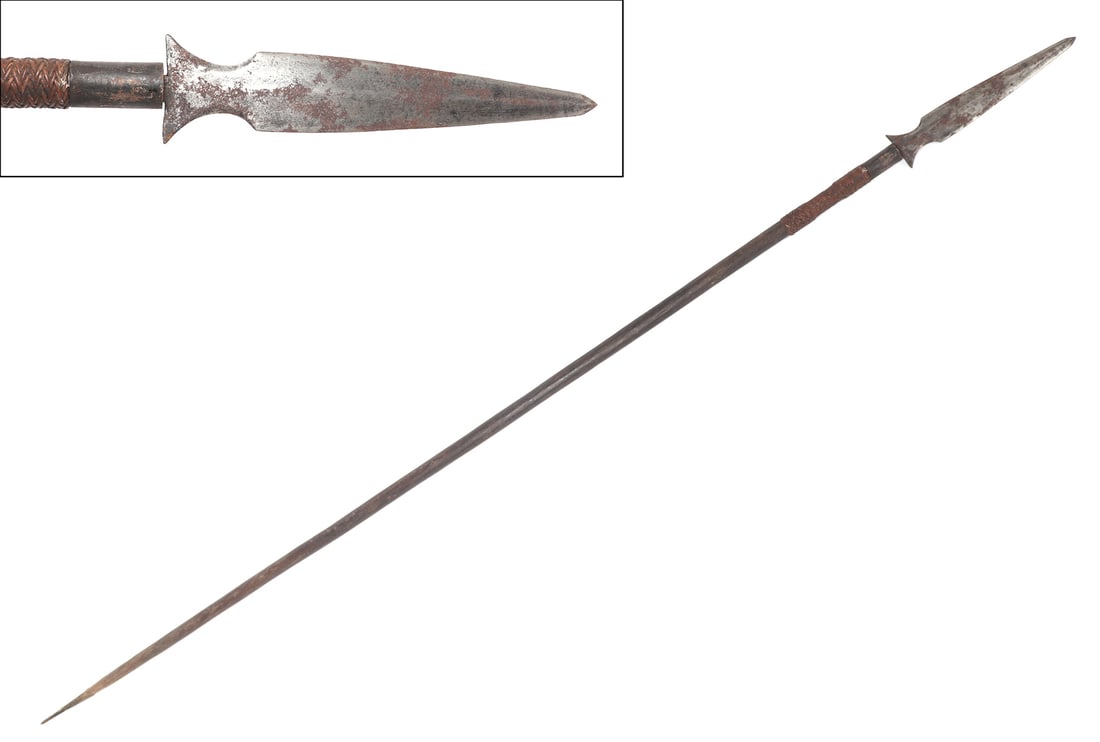 Philippine War Spear, 20th c.: Philippine Archipelago, war spear with triangular double edged spear point, slightly curved barb ends to the base, and a long wood shaft with a iron ferrule. Size 74" L, spear head 10 1/2" L