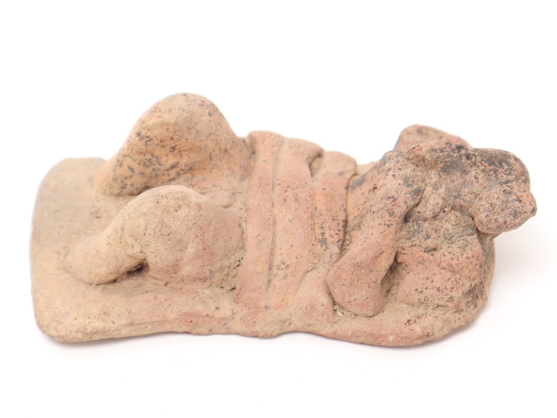 Colima Terracotta Bed Figure, 300 BCE - 300 CE: Pre-Columbian, West Mexico, Colima 300 BCE - 300 CE in terracotta of a figure strapped to a bed. Knees raised with arms at his face coping with sickness. Size 3" L x 1 3/4" WEx-USA Collection, Ex-Casa