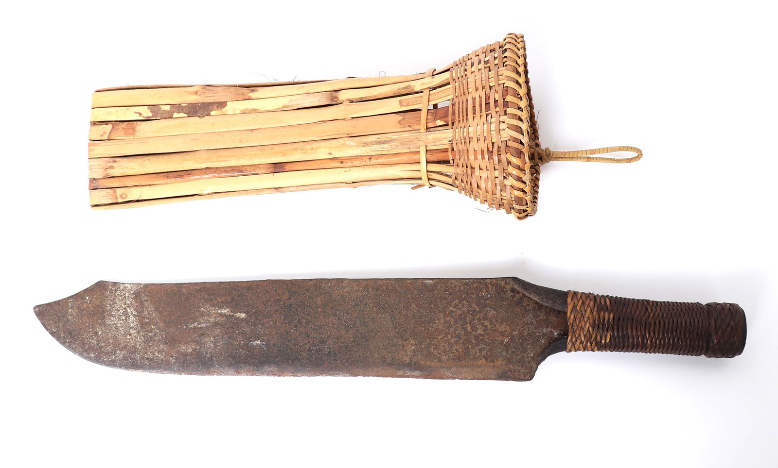 Philippines Machete w/ Sheath: Philippines probably Bagobo machete (knife) with sheath from the 20th century. The knife is slightly curved with a folded steel handle covered in rattan wrapping. Size overall 20" L, blade 14 1/2" L