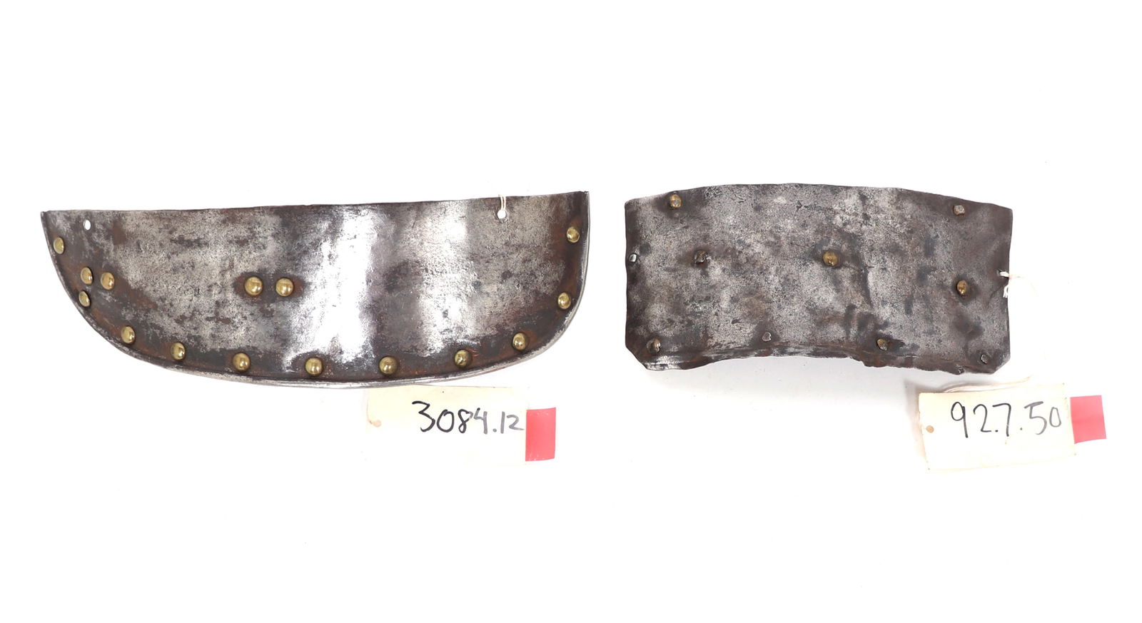 Two Elements of Armour, 16th-17th c.: Two authentic armour components of armour including the left example which is likely a lower lame of a tasset with heavy brass rivets, 17th century. Right an early component of armour with brass and s