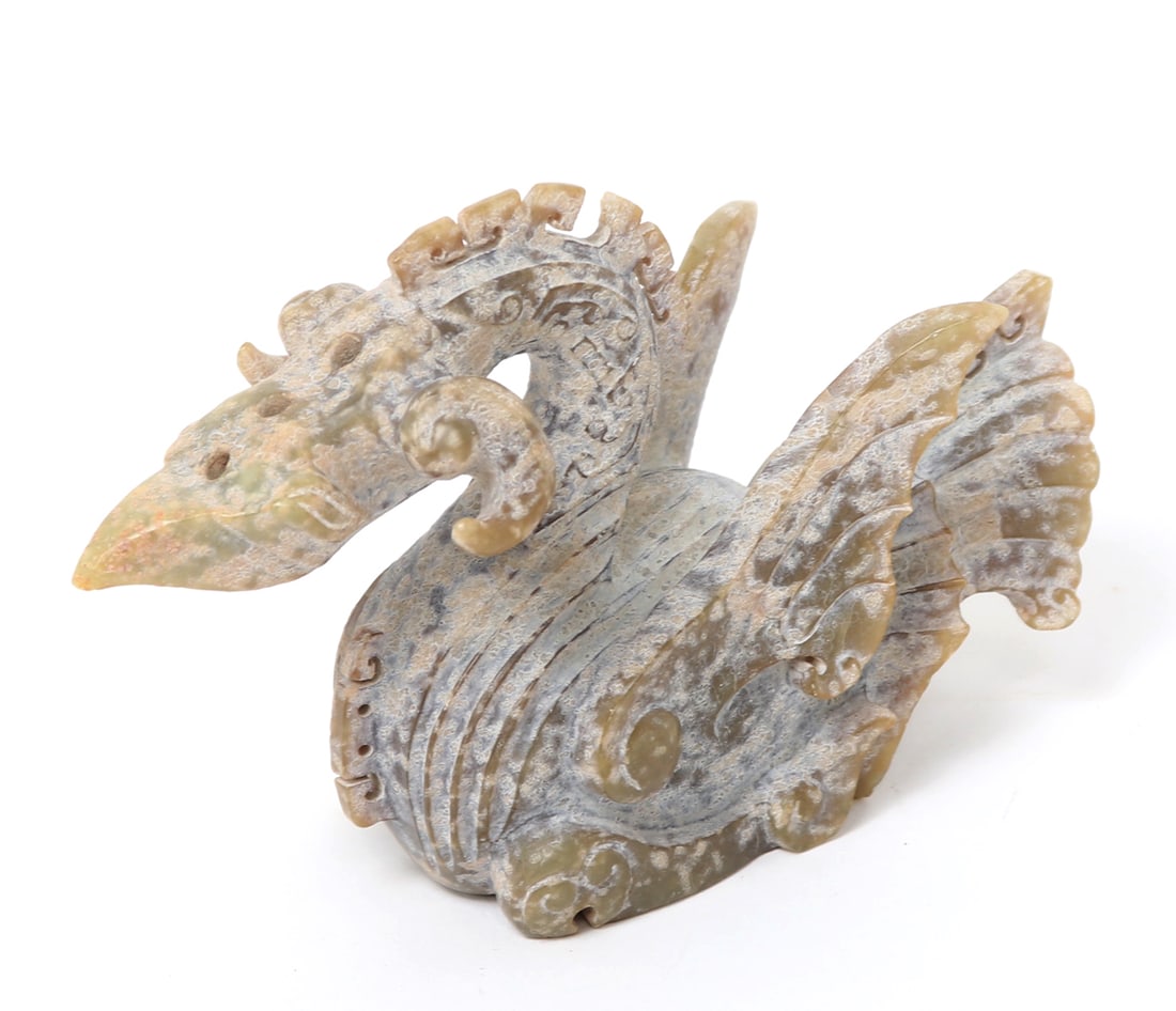 Chinese Avian Beast Jade Carving, 643 grams: Chinese archaistic style carving in tan and green jade of a avian beast. Pierced with several holes to the skull probably for retention of incense. Size 4" H x 6 1/4" W, 643 grams Ex-Southern Californ