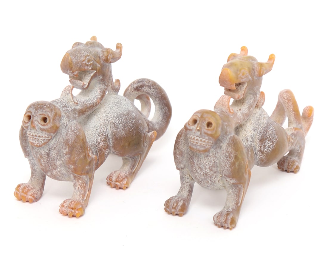 Pair of Chinese Hardstone Hongshan Dragons, 850g: Nice pair of well carved Chinese hardstone Hongshan style pig dragons atop mythical four-legged creatures with skull faces and long tails. Intricate carved details, well defined skull faces and even d