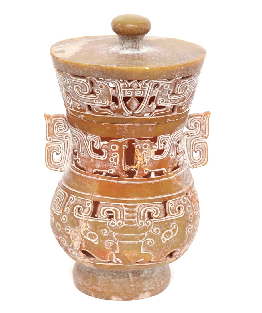 Chinese Hardstone Openwork Vase w/Lid: Chinese pierced openwork vase with lid in jade or hardstone archaistic style. Probably carved in a semi translucent soapstone for use as a censor or candle. Size 8 1/2" H x 5 1/2" W and includes a cus