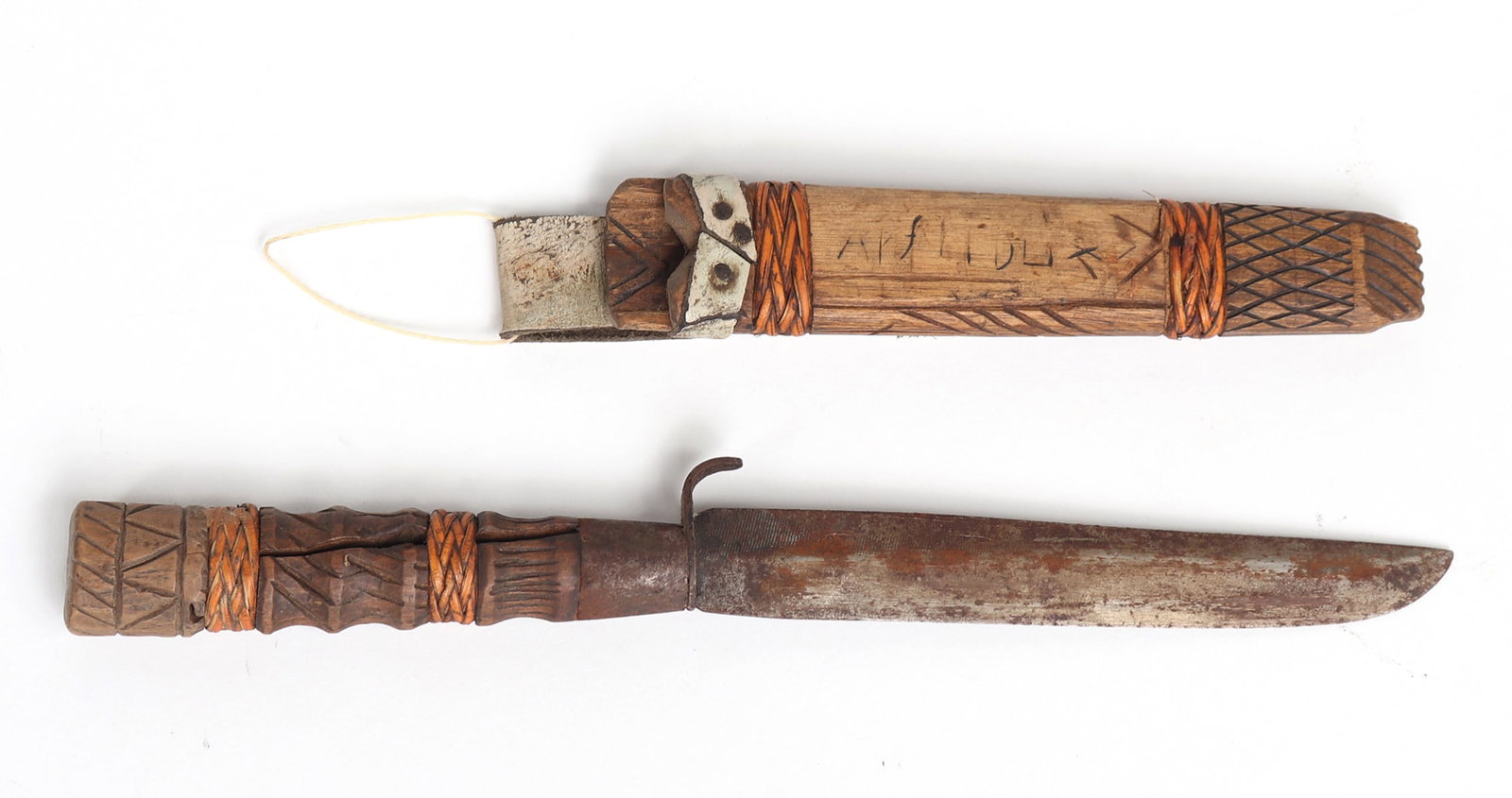Filipino Knife w/ Sheath: Filipino knife with single sided cross guard, rattan wrapped incised wood handle and wood, rattan and leather sheath. 9 1/4" L, blade 5 1/4" L