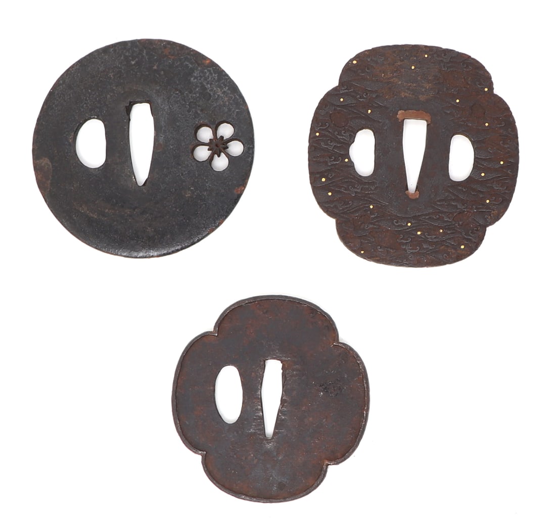 Collection of Three Antique Japanese Iron Katana Tsuba: Lot of three Japanese tsuba, probably Edo-Period. One circular form with a pierced openwork Mon. Two additional examples including one with a highly detailed surface of waves in chiseled detail. Size 