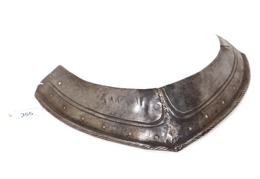 Element of Armour, 16th c.: European element of armour for the right pauldron with a slightly more extended side. 16th - 17th century, light embossing and with a roped edge. Size 11 1/2" WEx-Southern California Collection, Ex-Lo