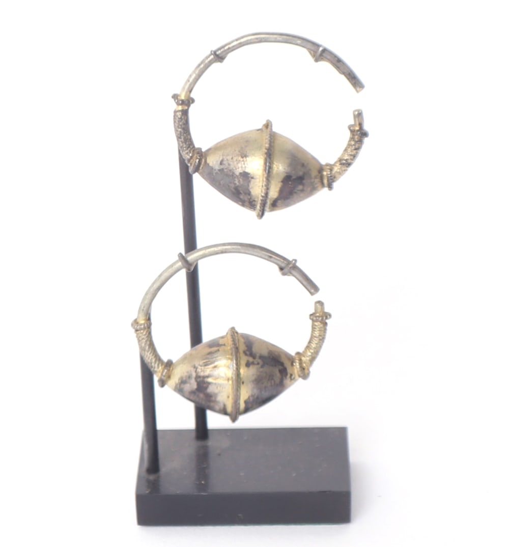 Byzantine Silver Gilt Earrings, 10th to 12th C. AD: Lovely matched pair of Byzantine gilt earrings. Each with hollow curved rods, conical sphere bisected by a rope work pattern. Very fashionable wearable ancient jewelry with a little work. Size of each