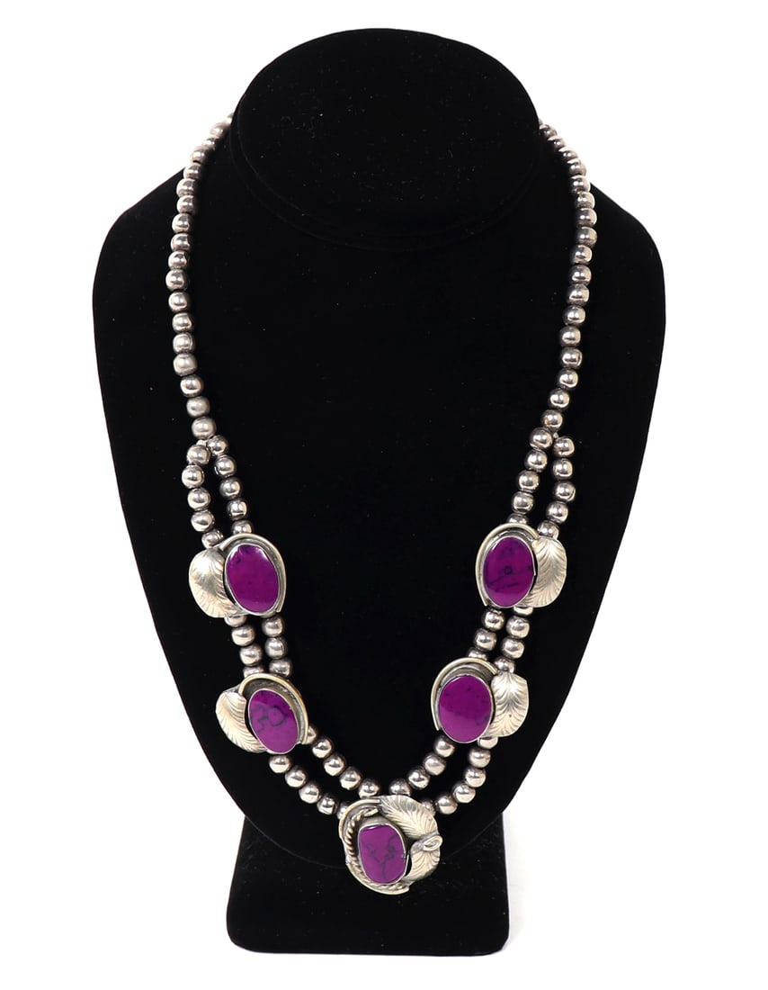 Beautiful Sterling Silver Squash Blossom Necklace: Gorgeous handmade sterling silver squash blossom necklace with dyed purple howlite cabochons surrounded by hand hammered and engraved leaf bezels. Five beautiful royal purple howlite cabochons with na