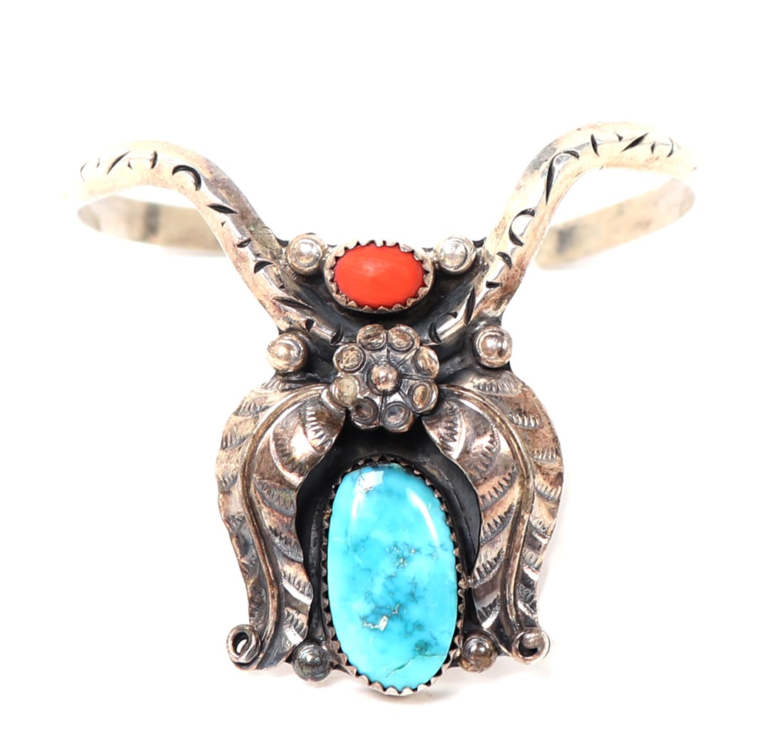 Gorgeous Native American Hand Made Cuff Bracelet: Lovely turquoise coral and sterling silver Native American hand made cuff bracelet. Turquoise stone surrounded by beautifully detailed sterling silver feathers with a flower crown. Size 1" opening, 2"
