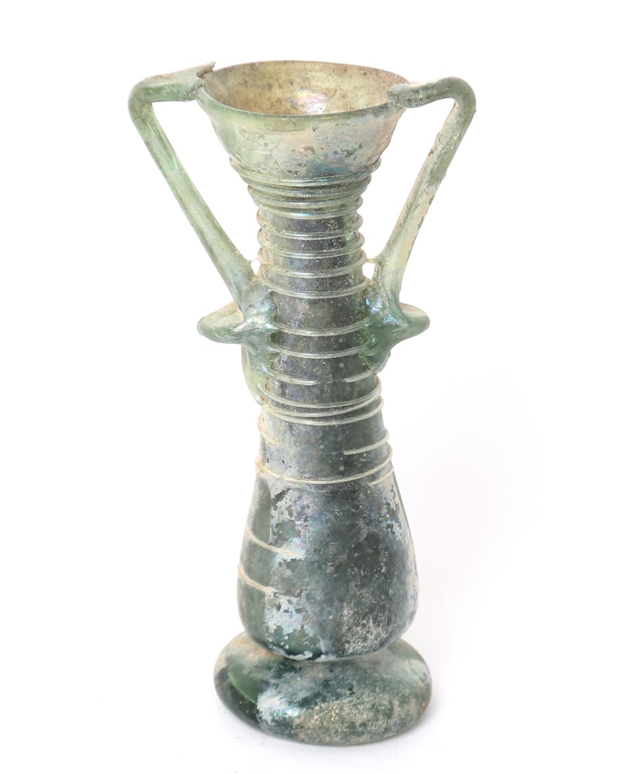 Roman Green Glass Double Handle Unguentarium: Gorgeous green glass vial with a swirl pattern to the long cylindrical chamber, twin loop handle trailed on, wide stable base and thick rolled lip. Leaning slightly to one side. Size 4 1/2" Hex-New Yo