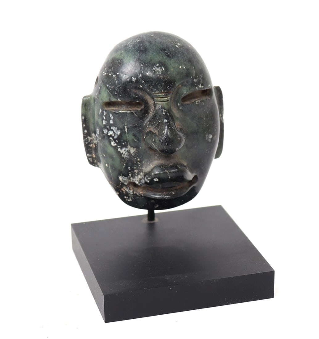 Pre-Columbian Stone Maskette, Monte Alban: Attractive green and blackish color stone carved mask, Zapotec probably authentic 500-1000CE. Reverse the mask has a circa 1970s label reading Monte Alban, a UNESCO world heritage sight and one time c