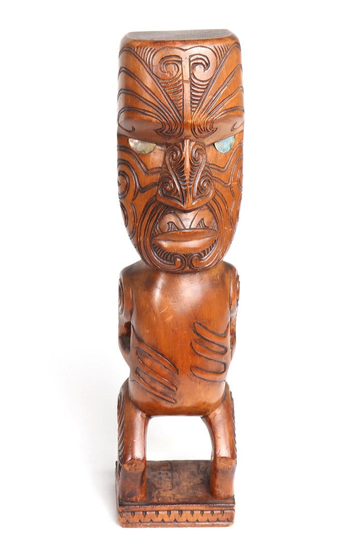 Vintage Maori Wood Standing Figure: Late 20th century wood carved Maori standing figure. Finely detailed wooden Maori Tiki statue with incised tattoo designs throughout his face, arms, legs and back. Black painted Moko face, with incisi