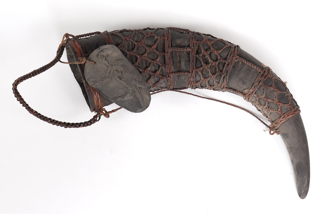 Filipino Powder Horn: Filipino powder horn with woven netted design and wooded cover decorated with lizard in relief. Size 19" L**Please Note - Scollard Auctions is closed until Jan. 2nd 2025, winning lots will not be ship