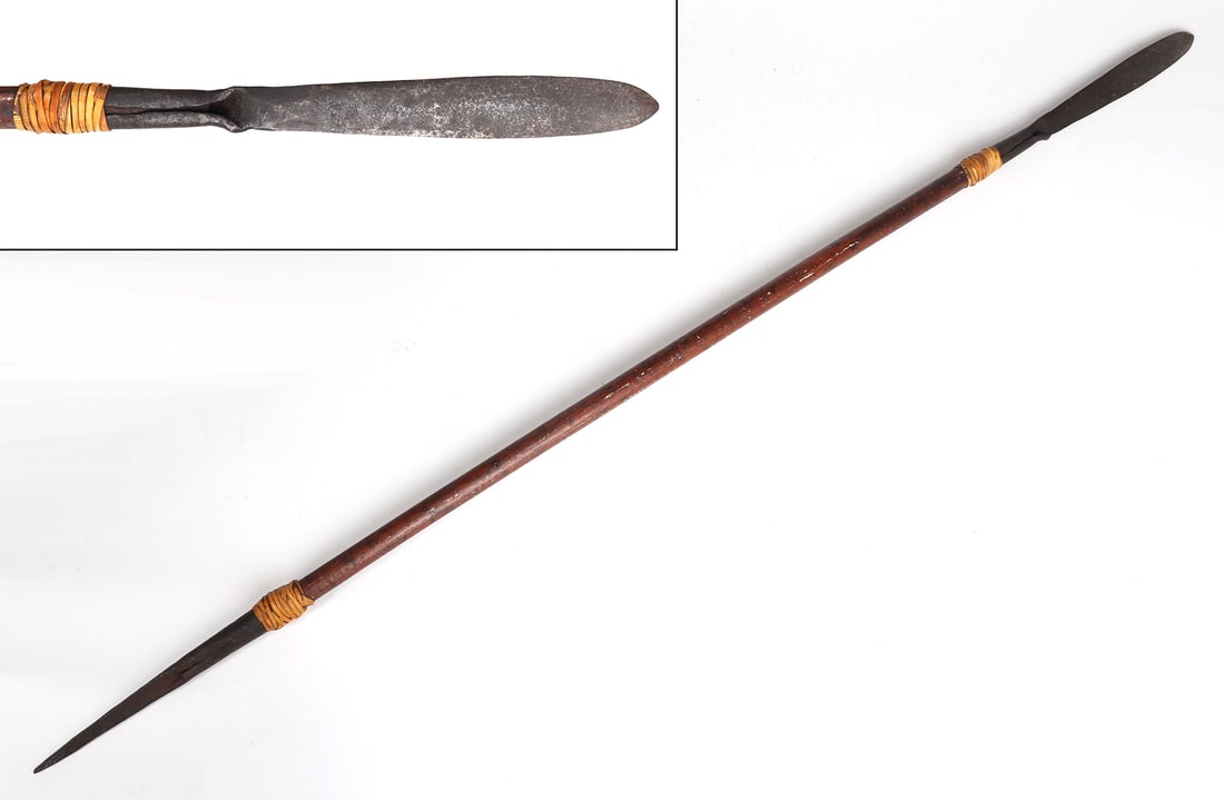 Philippines Rattan Wrapped Sibat: Filipino war spear with heavy wood shaft. Blade of iron, thickened at distal end and tapering toward shaft, hardwood shaft ferruled with rattan and punched with brass rivets. Size 53" H, spear blade 8