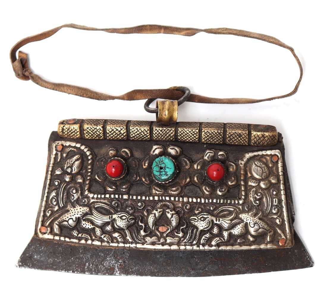 Tibetan Silver Embossed Chuckmuck Fire Starter: Central Asia, Tibet, antique 19th century fire start or chuckmuck. Heavy brass binding with loop and leather strap. Leather body with affixed panels of embossed silver of zoomorphic creatures and scro