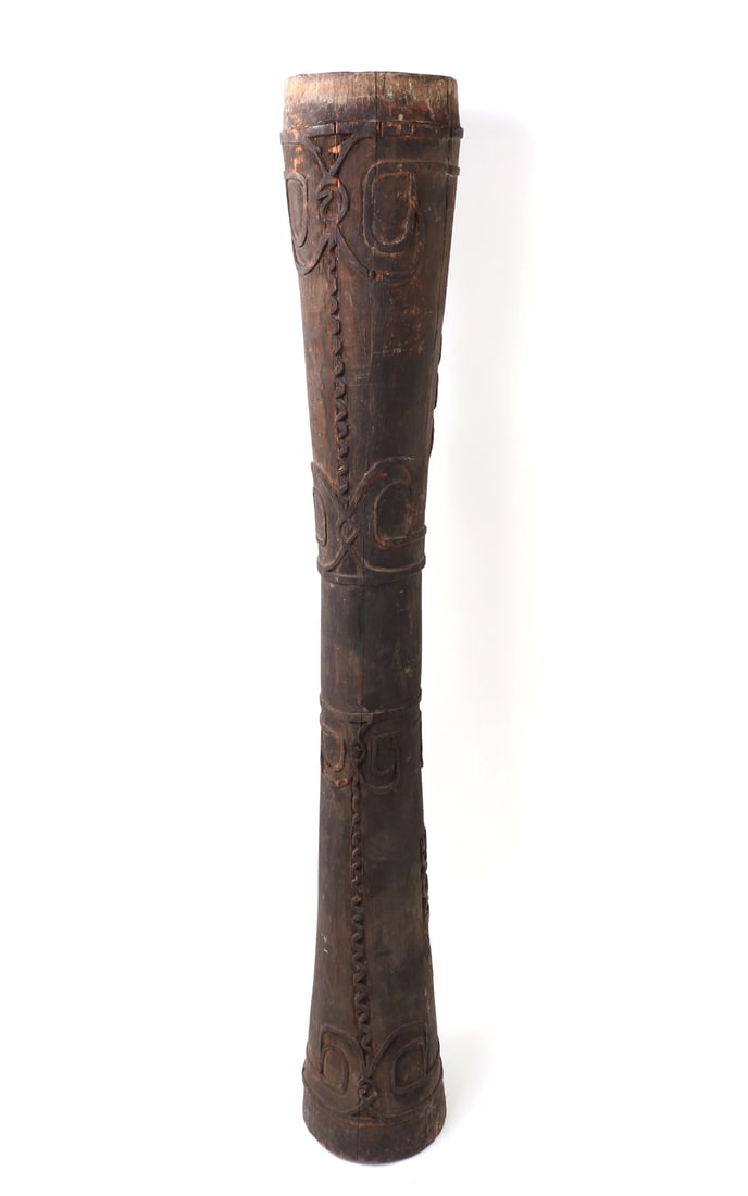 Tall Indonesian Wood Carved Kundu: Lovely tall Indonesian carrying drum with intricate openwork handle with repeating zoomorphic like creatures with incised banding and facial details. Size 57" L x 8" W x 8" H