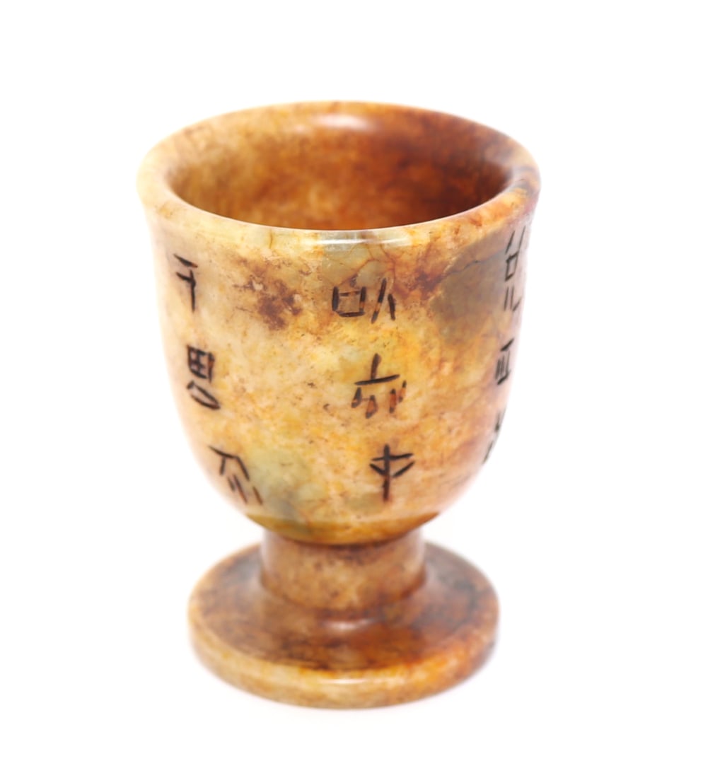 Adorable Chinese Stone Carved Teacup: Chinese hardstone carved teacup or shot glass, with a pedestal base and wide opening. Calligraphy markings throughout likely a poem or dedication. Size 2 3/8" H