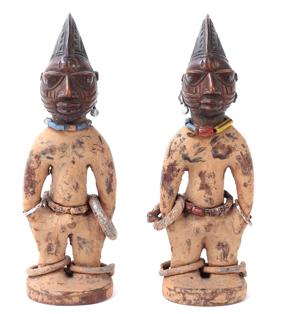 Early Twin African Ibeji Figures: Yoruba Peoples pair of twin Ibeji statues covered all over in a lovely ochre paste called camwood from the neck down. Each piece intricately carved from a single piece of wood, decorated with beautifu