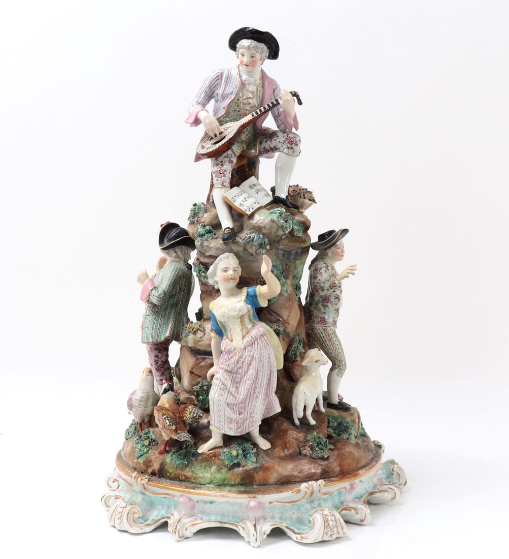 Meissen Style Porcelain Centerpiece, 19th c.: Wonderful porcelain Meissen style centerpiece with a fantastic scene of a musician playing atop of a natural plinth for animals, birds, and dancing figures. Probably Germany Circa late 1800s. Size 18"