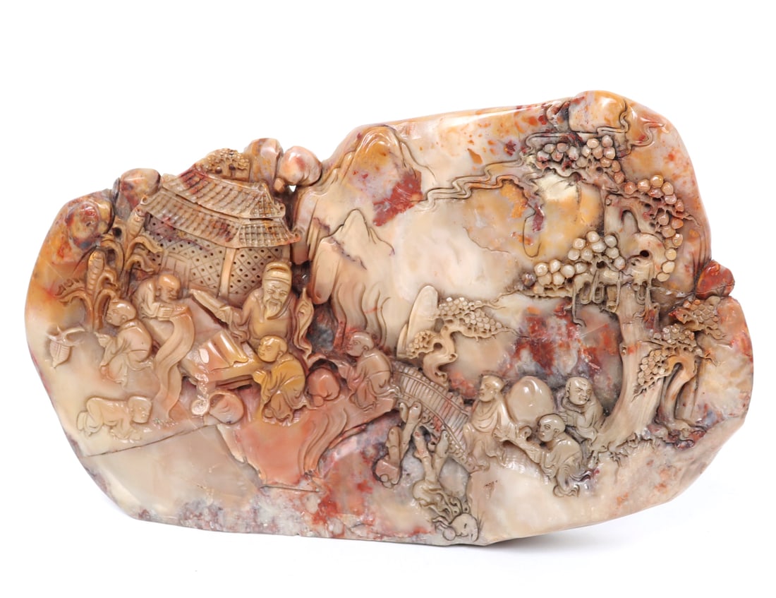 Chinese Soapstone Mountain Carving: Excellent quality high relief carving of a Chinese soapstone mountain with detailing to the face of a lounging royal figure and procession of attendants. Scene of the side with attendants carrying pea