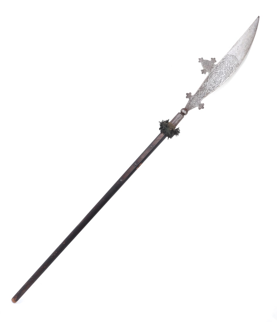 Etched Parade Polearm, Circa 1590-1617 Style: Great etched Glaive or Flauchard polearm with intricate decoration to either side of scrolling and floral motifs surrounding a "F" probably for Emperor Ferdinand of Austria. Reverse with similar scrol