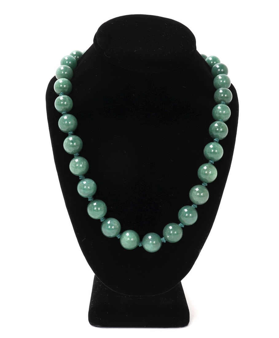 Lovely Chinese Jade Beaded Necklace: Chinese jade beaded necklace strung together on a silk style thread with a marker silver clasp. Clasp in a beautiful basket weave design with intertwined currency. Beautiful coloring throughout each u