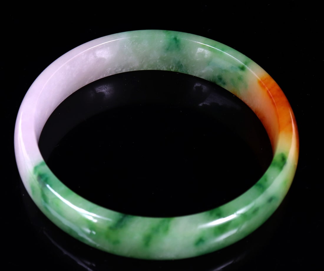 Gorgeous Chinese Rainbow Jade Bangle Bracelet: Chinese bangle bracelet comprised of incredible rainbow coloring including lavender purple, candle light yellow leading to a fire orange and lovely light to dark green marbled jade. Size 3" L x 3" W
