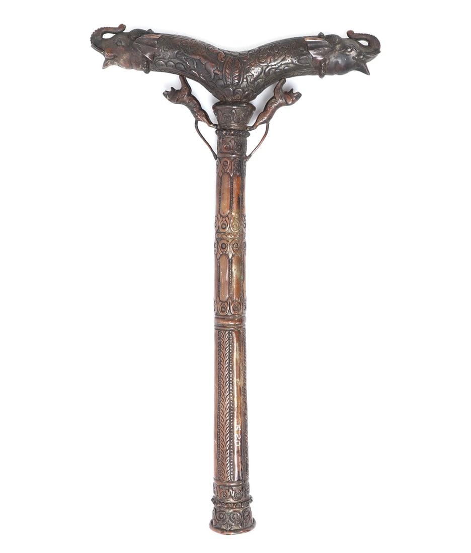 South Indian Embossed Krutch, Circa 18th-19th C: Beautifully embossed Indian copper crutch rest with elephant head ends and a thick shaft. The base of the shaft with hollowed opening. Zoomorphic and floral motifs throughout. Size 19" H x 11 1/4" W