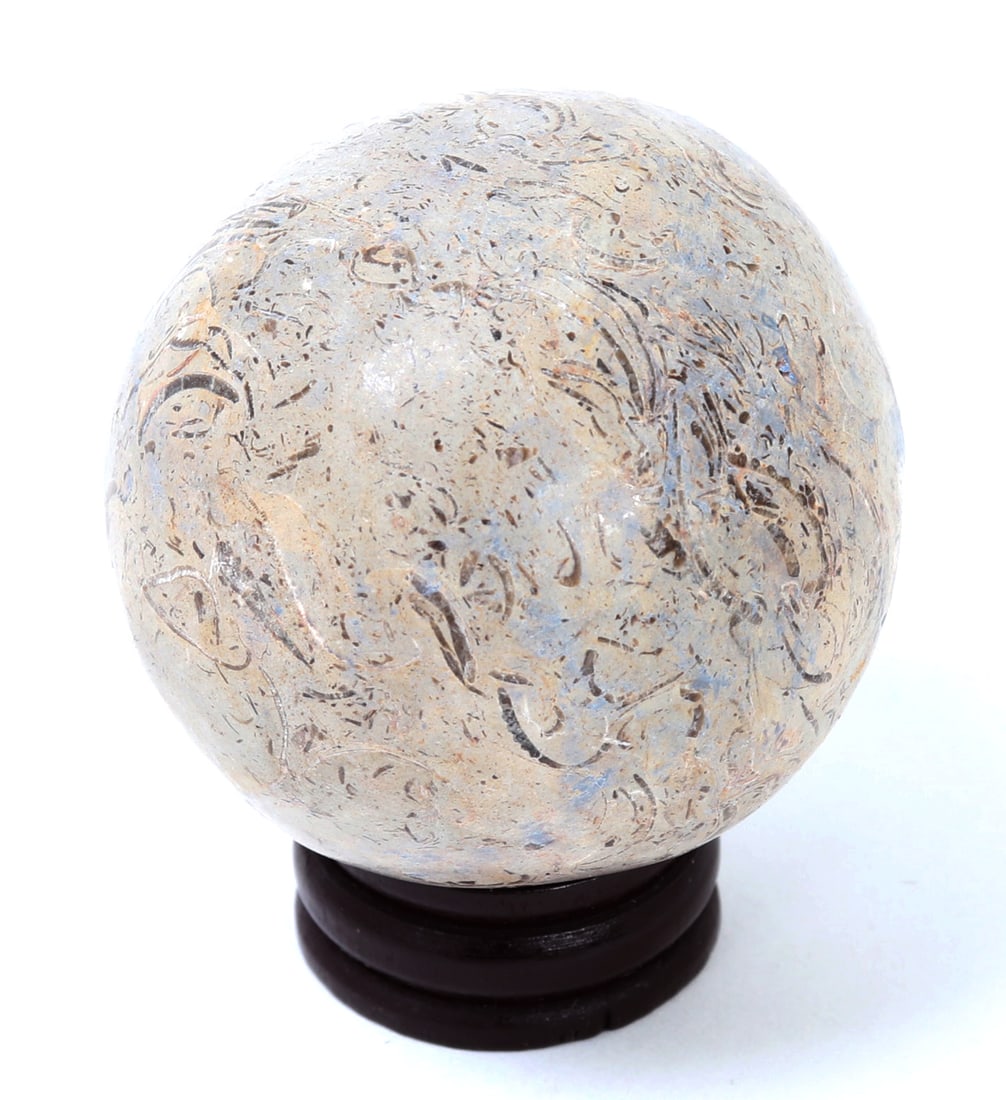 Finely Polished Dinosaur Bone Sphere w/Stand: Nicely polished and perfectly shaped dinosaur sphere with custom wood stand. Incredible marbling and detail throughout with some bluing and cream colors throughout. Size with stand 2 1/2" H x 2" W, al