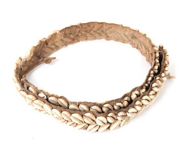 Papua New Guinea Head Hunter's Cowrie Shell Belt: Finely woven PNG head hunters cowrie shell belt with dozens of repeating shells throughout. Would have held a dagger with a sheath. Size 4' L