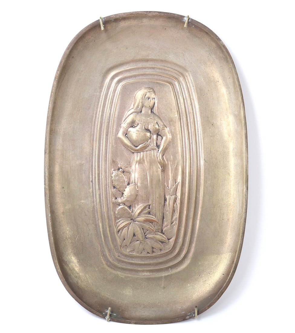 Silver Plated Platter, Repousse Design of a Woman, 1930's: Circa 1930's. Lovely silver plated platter depicting a woman standing with a clay water pot in one arm and her other hand resting on her hip. Standing among cactus and agave plants. Size 14 1/4" H x 9