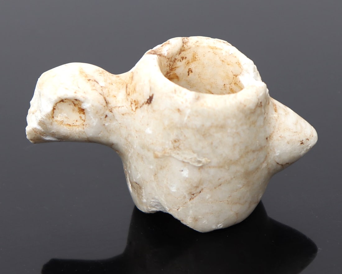 Avian Form Pendant, Taino 1000CE - 1500CE: Pre-Colombian, Caribbean, Taino peoples 1000CE - 1500CE. Nicely formed avian pendant with a large pierced opening to the body. Skull in typical Taino style with deeply recessed darkened eyes, small pr
