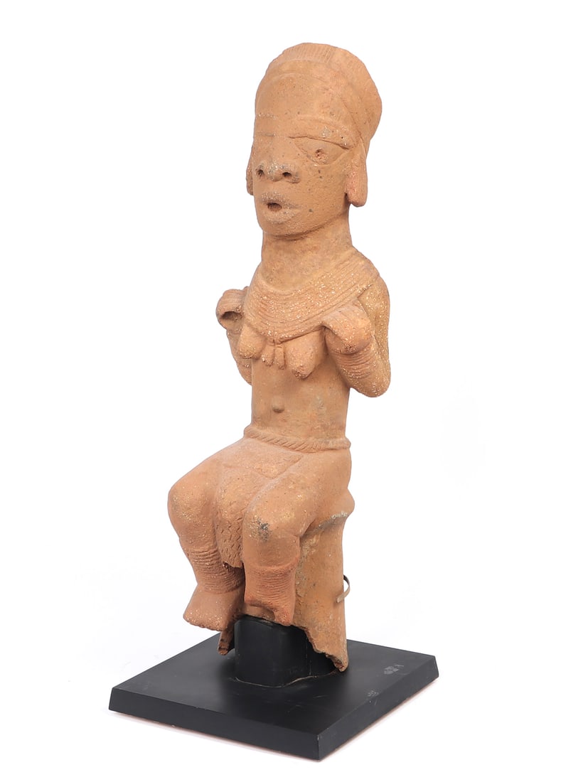 Monumental African Nok Terracotta Figure, Daybreak TL 1500 BCE-500 CE: Monumental and Truely Magnificent Nok Female Seated Figure on custom stand. She is seated with very fine detailing and finish, minimal shell visible throughout the slip and still with great detail to 