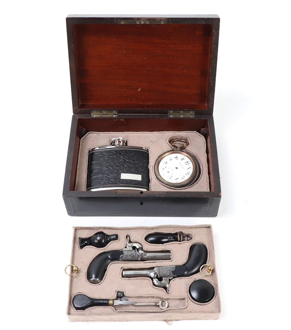 Cased Set of Percussion Drop Trigger Pistols: Two tiered cased set of drop trigger screw barrel percussion pistols circa 1850. Pair percussion pistols with trigger which drops down upon cocking the gun. Barrels screw off to additionally reduce si