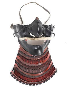 Japanese Armour Menpo Mask: Japanese armour Menpo mask, likely Meiji Period. Menpo exhibits classic construction with a black painted metal and features a bristled mustache and chin guard. The red lacquer on the lower section en