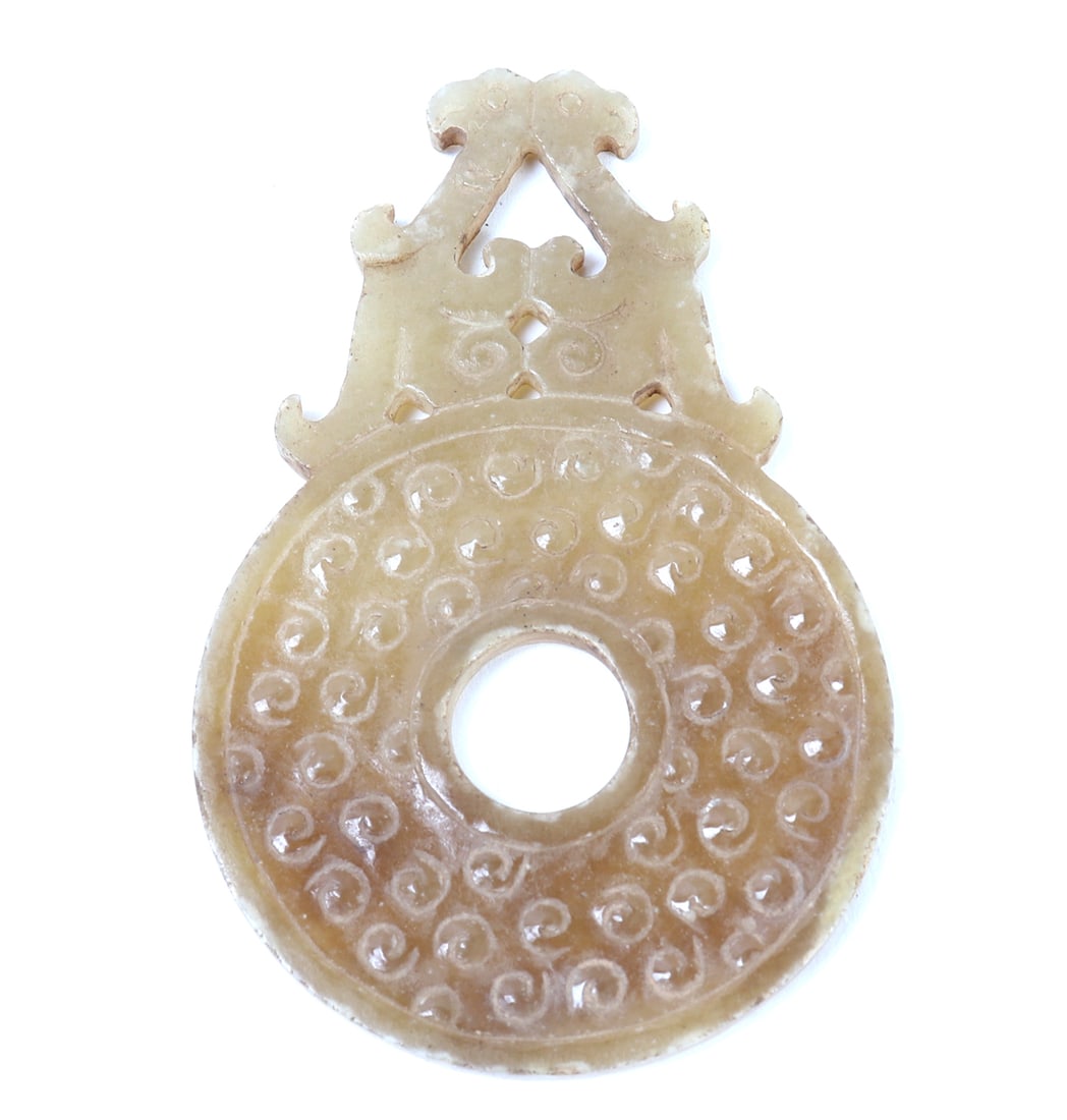 Chinese Archaistic Jade Style Plaque: Finely carved archaistic style jade pendant with reverse phenix finials to the top. Openwork to the center for suspension with a textured surface. Size 3 1/8" L, weight 23 g