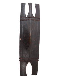 Ifugao Shield, Luzon Province: Finely made Philippines Luzon shield of the Ifugao tribe in a dark black patina and rattan wrapping. Carved with three legs to top and two to the bottom with a deeply convex center section to accommod