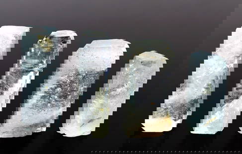 Group of Four Natural Aquamarine Crystal Terminals: Wonderful collection of natural translucent aquamarine crystals in various tower shapes. Faint hints of blue throughout each piece. A wonderful addition to any mineral collection. Size biggest one 7/8