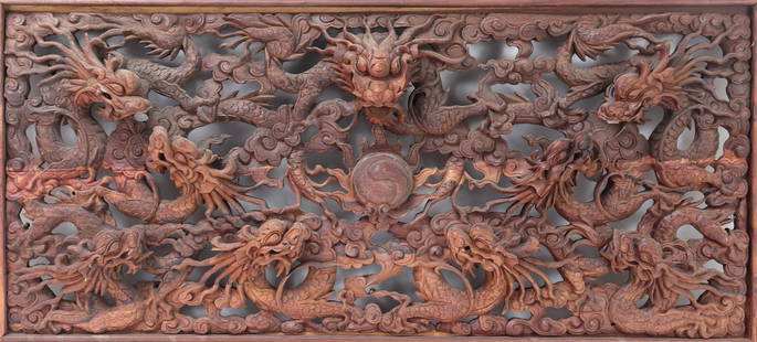 Chinese Wood Carved Dragon Window Panel: Heavy wood carved Chinese dragon window panel, depicting dragons all on the hunt of a flaming pearl at the center. Intricately detailed and carved throughout with wonderful attention to craftsmanship.