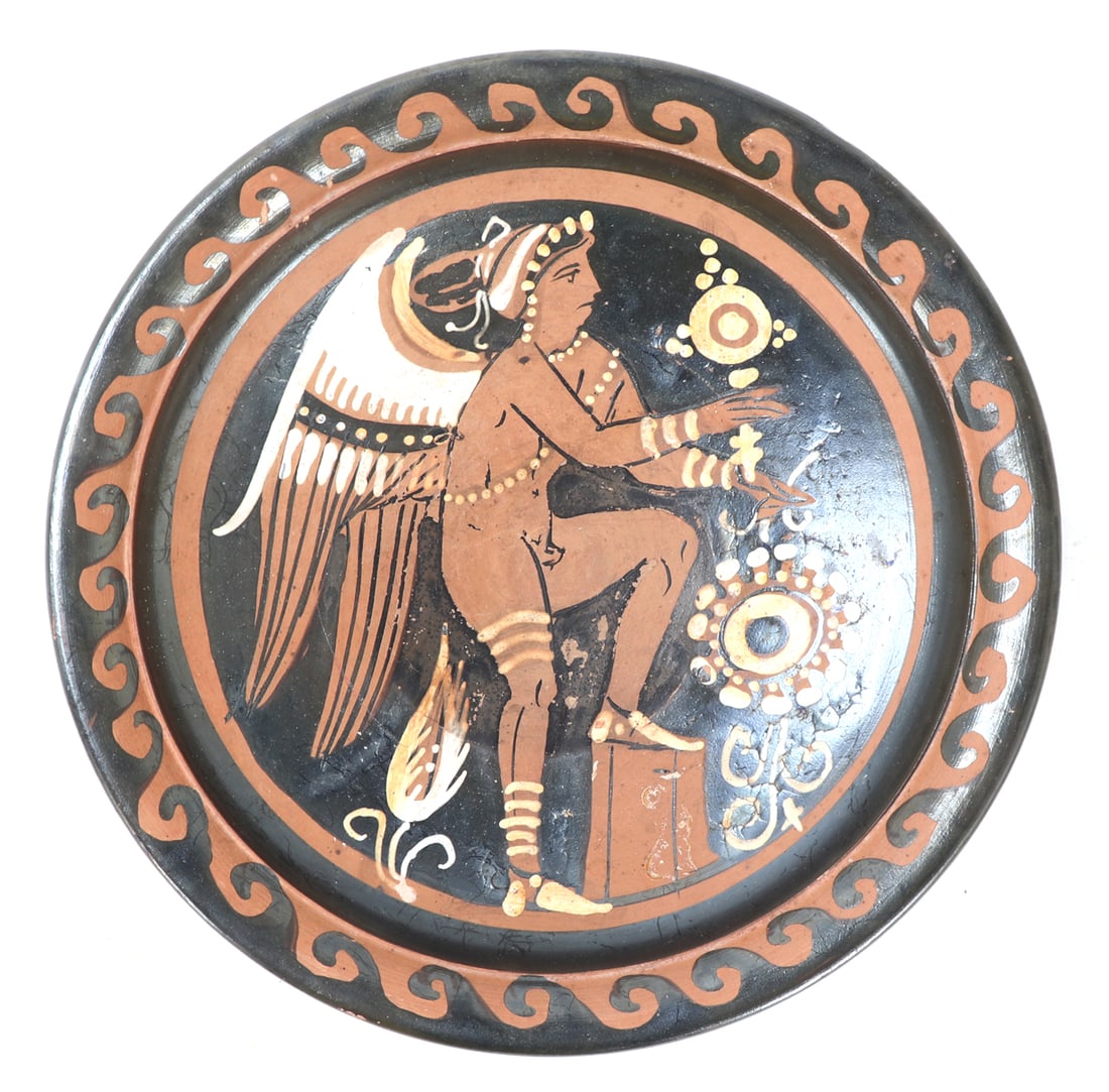 Greek Apulian Red-Figure Plate, Winged Eros: Magna Graecia, Southern Italy, Apulian, ca. 340 to 320 BCE. Wonderful Greek Apulian footed plate depicting a young red painted winged Eros, he stands with his left foot resting on a pillar. Eros is nu