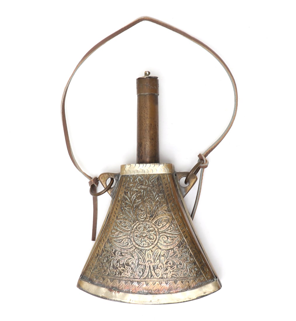 Islamic Brass Powder Flask, 19th c.: Islamic brass engraved powder flask in geometric form. Probably Morocco 19th century. Long copper spout with original stopper. Two suspension loops at either side of the top of the flask. Bands of sil