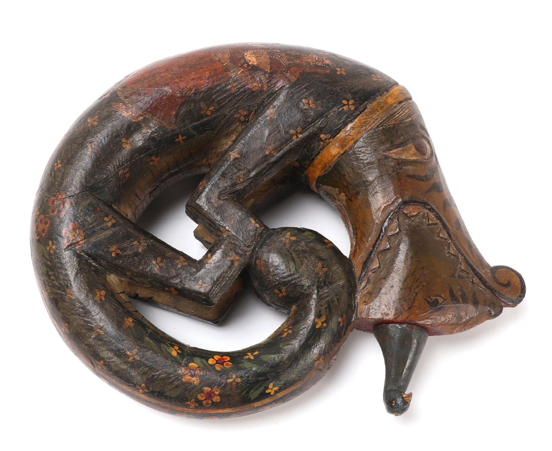 Indian Dragon Shaped Powder Flask, 20th c.: Indian dragon or beast shaped powder flask carved from wood and painted, 20th century. Within the jaws of the beast a removable bird in blue cap. The creature itself painting in lighter colors to the